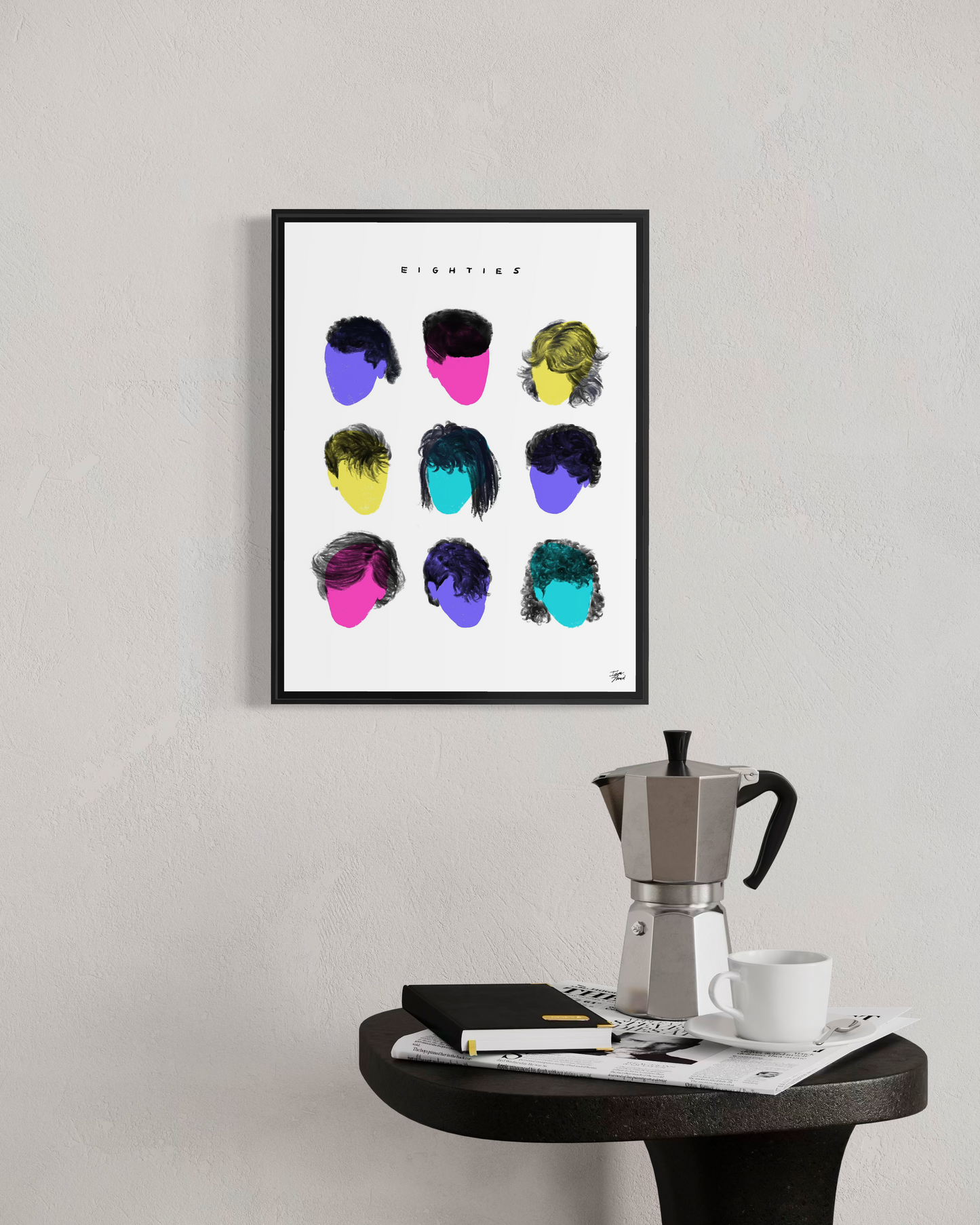 Vaykay-Idanshani Eighties Series framed print in a modern industrial interior. The bold 3x3 grid of retro hairstyle shapes is displayed above a dark concrete counter featuring a stack of design books and a vintage Moka espresso pot.